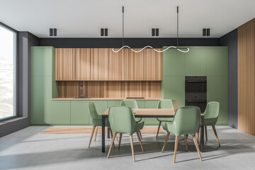 Green kitchen interior with seats and eating table, shelves and window