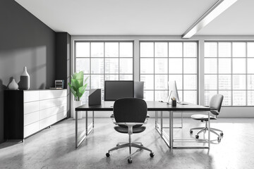 Workplace interior with desk, computer, shelf and window with city view