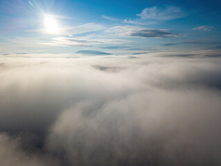 Fototapeta premium High flight above the clouds. Aerial drone view.