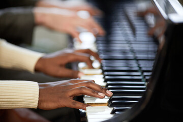 Close-up of woman playing the piano together with man in duet during their performance - obrazy, fototapety, plakaty