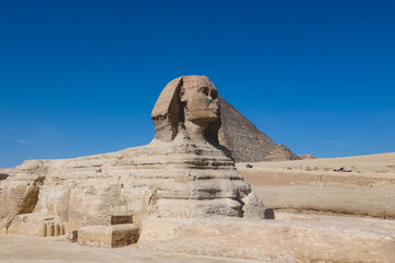 Main View to the Great Sphinx of Giza, is a giant limestone statue with the Great Pyramid in...