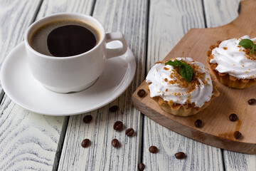 Delicious morning breakfast. Coffee with mint cakes on the background of an old white wooden countertop.