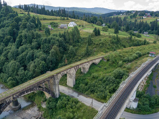 Obraz premium Old railway bridge in the mountains. Ukrainian Carpathians. Aerial drone view.