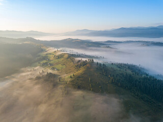 Sunrise over the fog in the Ukrainian Carpathians. Aerial drone view.