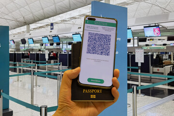 Vaccine pass in mobile phone app and passport required to take airplane, train, high speed rail and...