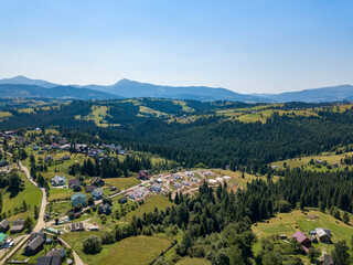 Green mountains of Ukrainian Carpathians in summer. Sunny clear day. Aerial drone view.