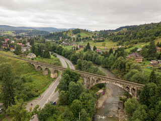 Old railway bridge in the mountains. Ukrainian Carpathians. Aerial drone view.