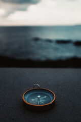 Compass travel in front of water ocean landscape. Concept of lost and destination wanderlust