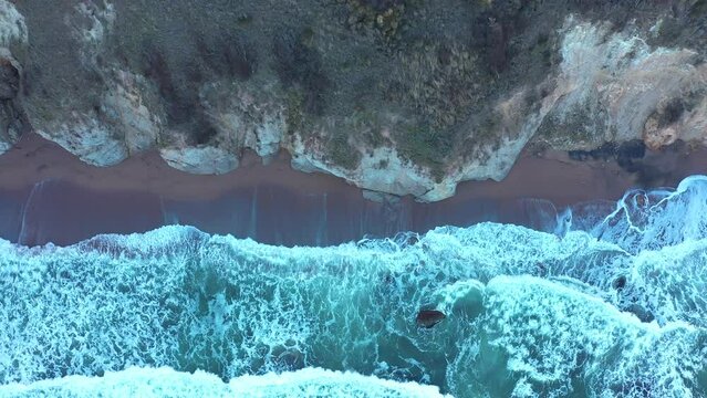 Aerial view to a beautiful wild rocky beach and big waves