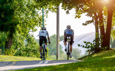 Cyclists ride on the bike path in the city Park
