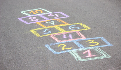 little girl plays hopscotch. selective focus