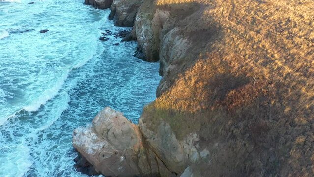 Aerial view to a beautiful wild rocky beach and big waves