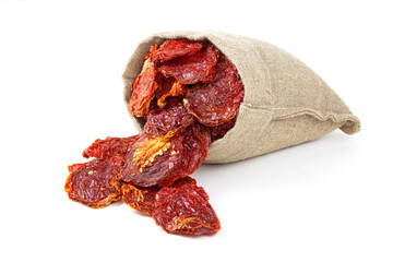 Dried tomatoes in a sack isolated on a white background. Sun dried tomatoes in jute bag.Healthy food