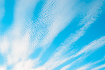 Soft clouds on blue sky in windy weather on sunny day outdoors