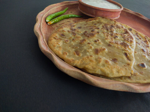 aloo paratha with curd served on plate. Traditional north indian food.