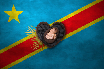 Newborn portrait in heart on background of national flag. Photography peace concept. Democratic Republic of the Congo