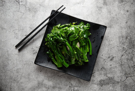 Steamed Green Vegetables On Black Plate