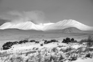 Black and white Majestic Alpen Glow hitting mountain peaks in Scottish Highlands during stunning...