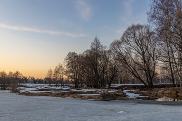 Melting ice and snow. Spring landscape, evening forest with a river. The beginning of spring....