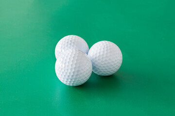 Golf balls on the green background