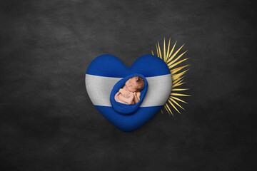 Newborn portrait on heart in color of national flag. Photography peace concept. Honduras