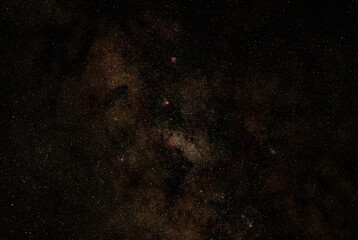 Fototapeta na wymiar Night sky with milky way near Scutum constellation, purple Omega, Eagle and Triffid nebula visible. Long exposure stacked photo