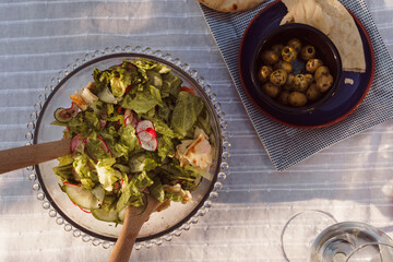 Macro shot of summer fatoush style salad in a bowl with olives in top right of frame. Rustic mezze...