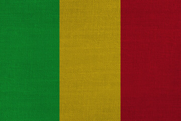 Patriotic textile background in colors of national flag. Mali