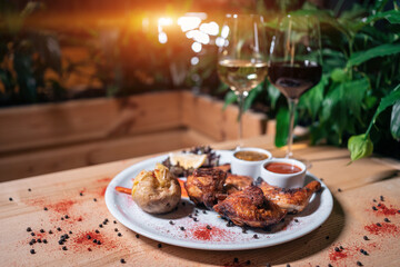 Fototapeta na wymiar Georgian cuisine dish roasted chicken tapaka on plate and wine in restaurant