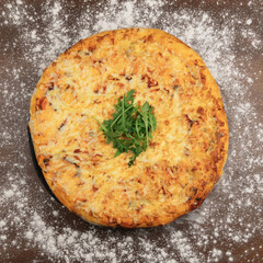 A big tasty pizza with salami, cheese and arugula