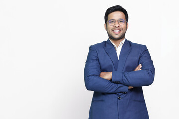 Young hispanic businessman with arms crossed smiling happy.