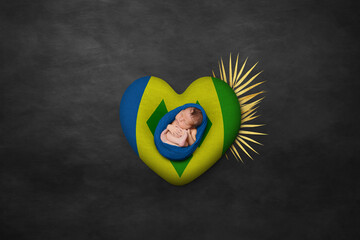 Newborn portrait on heart in color of national flag. Photography peace concept. Saint Vincent and...