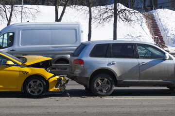  A traffic accident on a slippery road involving a taxi service. Concept - a taxi car crashed due...