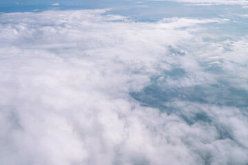 Obraz na płótnie Canvas Blue sky and Clouds as seen through window of aircraft