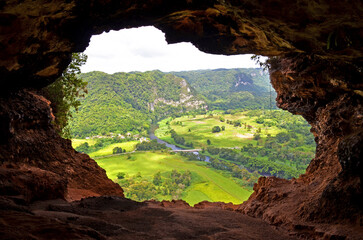  Window Cave (Cueva Ventana) in Arecibo near San Juan, Puerto Rico. View through lush green scenery...