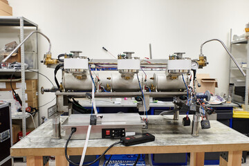 the insides of a professional coffee machine against the background of a workshop without a case