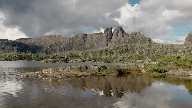 rocky shore at lake elysia with mt geryon in the background at the labyrinth in cradle mountain-lake st clair national park of tasmania, australia