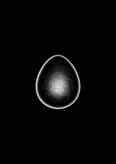 Chocolate easter egg with silver Aluminium foil on black background.
