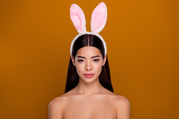 Portrait of sweet asian girl wearing headband adorable bunny ears holiday concept bare skinny shoulders isolated pastel background