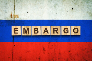 Embargo. Word on wooden blocks. Against the background of the flag of Russia. Business. Politics.