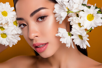 Obraz na płótnie Canvas Close up photo headshot of asian pretty girl among flowers visage gentle flirt deep eyes look isolated pastel color background
