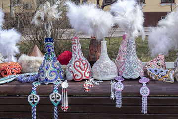 Traditional headdresses with feathers of girls from Kazakhstan and Central Asia in a street market store. Handmade