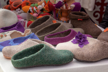 Handmade felt shoes on the counter of a street fair