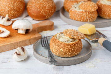 Julienne in sesame buns. Bread roll baked with cheese, mushrooms, chicken and bechamel sauce in a...
