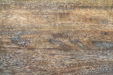 Mango wood texture with streaks of colors and mottled grain pattern