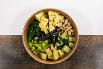 fresh bowl with mango, green beans, nuts, seaweed and avocado