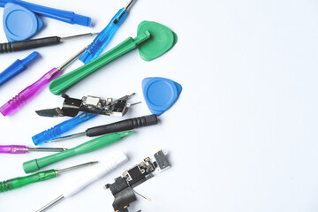 Kit of tools for repair mobile phone: screwdrivers,  equipment and printed circuit boards (pcb) for restoring on a white background with space for text 
