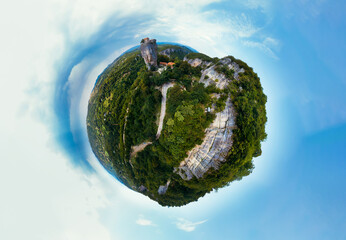 Fototapeta premium Little planet view. Katskhi pillar. Georgian landmarks. Man's monastery Katskhi. The orthodox church and the abbot cell on a rocky cliff. Imereti, Georgia. Summer day. Travel and tourism