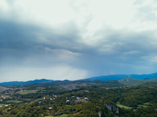 Naklejka premium Aerial. Mountains Georgian landmarks, nature. Green forest. View from monastery rocky cliff. Katskhi Georgia. Summer day. Travel and tourism.