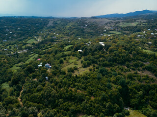 Fototapeta na wymiar Aerial. Mountains Georgian landmarks, nature. Green forest. View from monastery rocky cliff. Katskhi Georgia. Summer day. Travel and tourism.